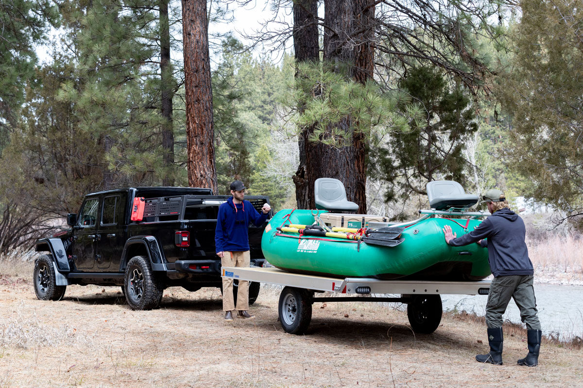 Two anglers getting ready to unload a fishing raft from an ALCOM trailer in Montana