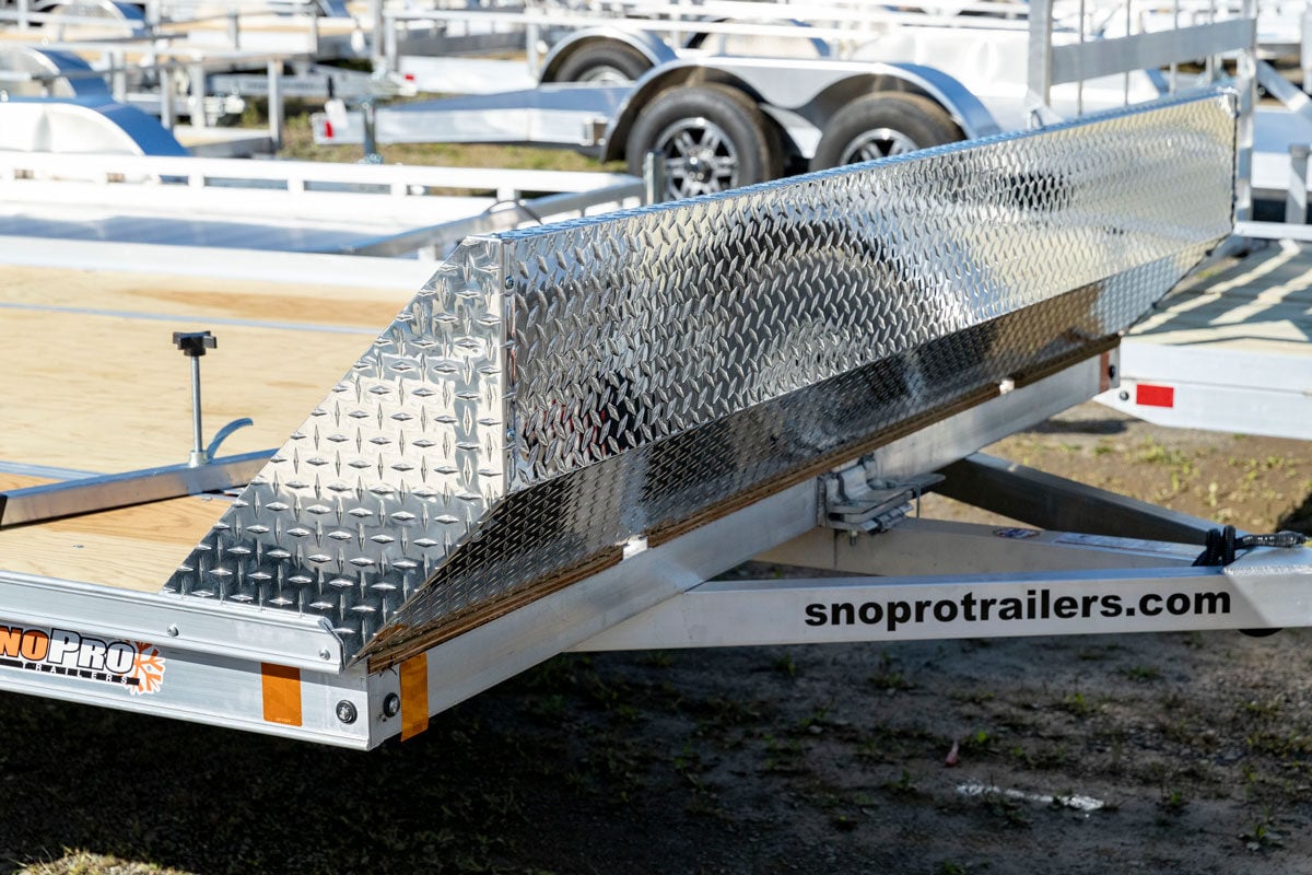 Open tilting snow trailer with diamond plate salt shield