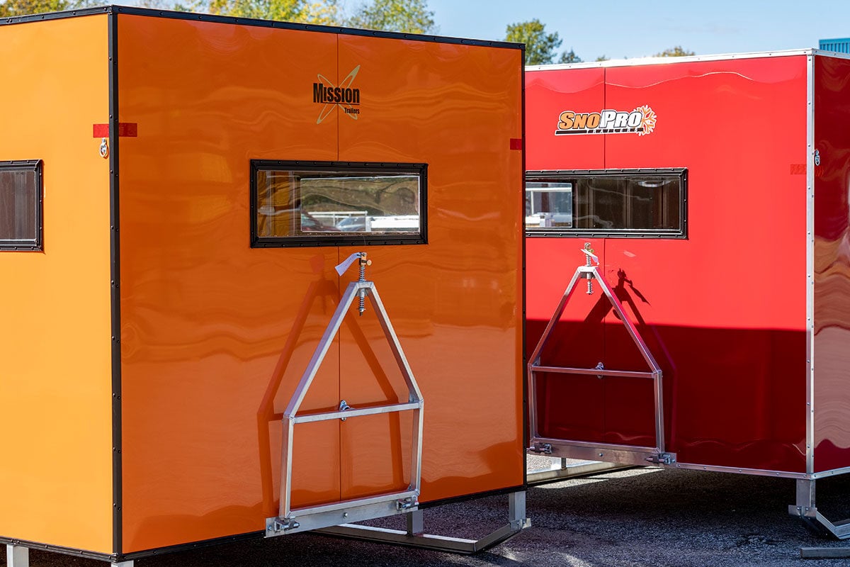 Orange and red ice shacks side by side