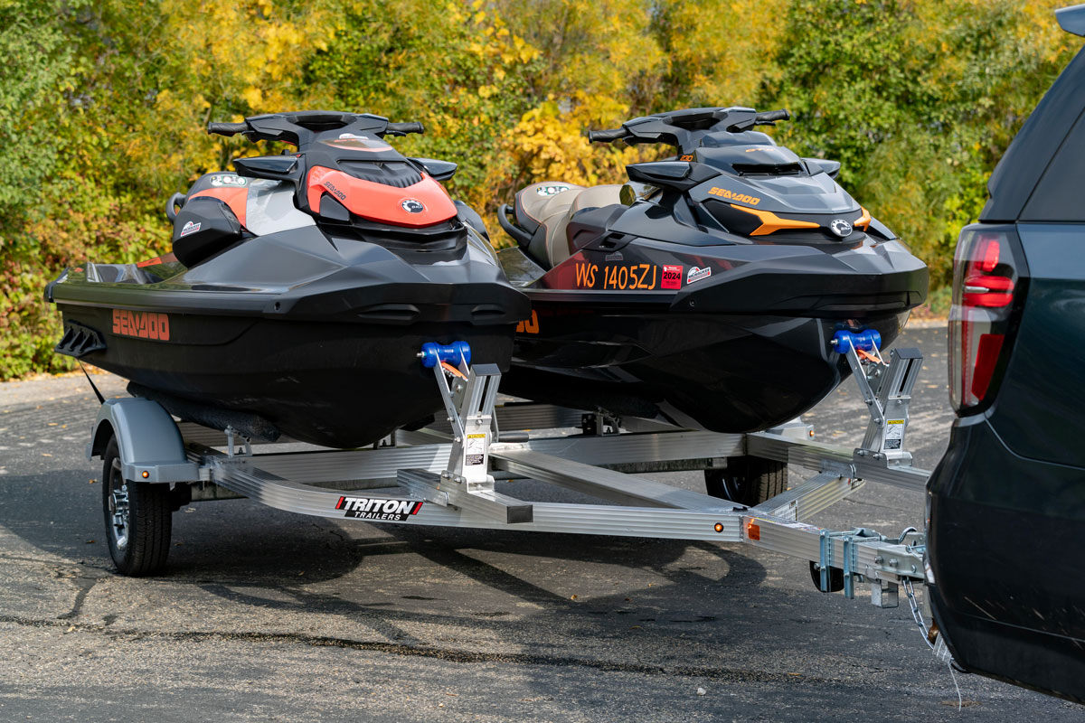 Two full size PWCs loaded on a parked ELITE Series aluminum PWC trailer from Triton