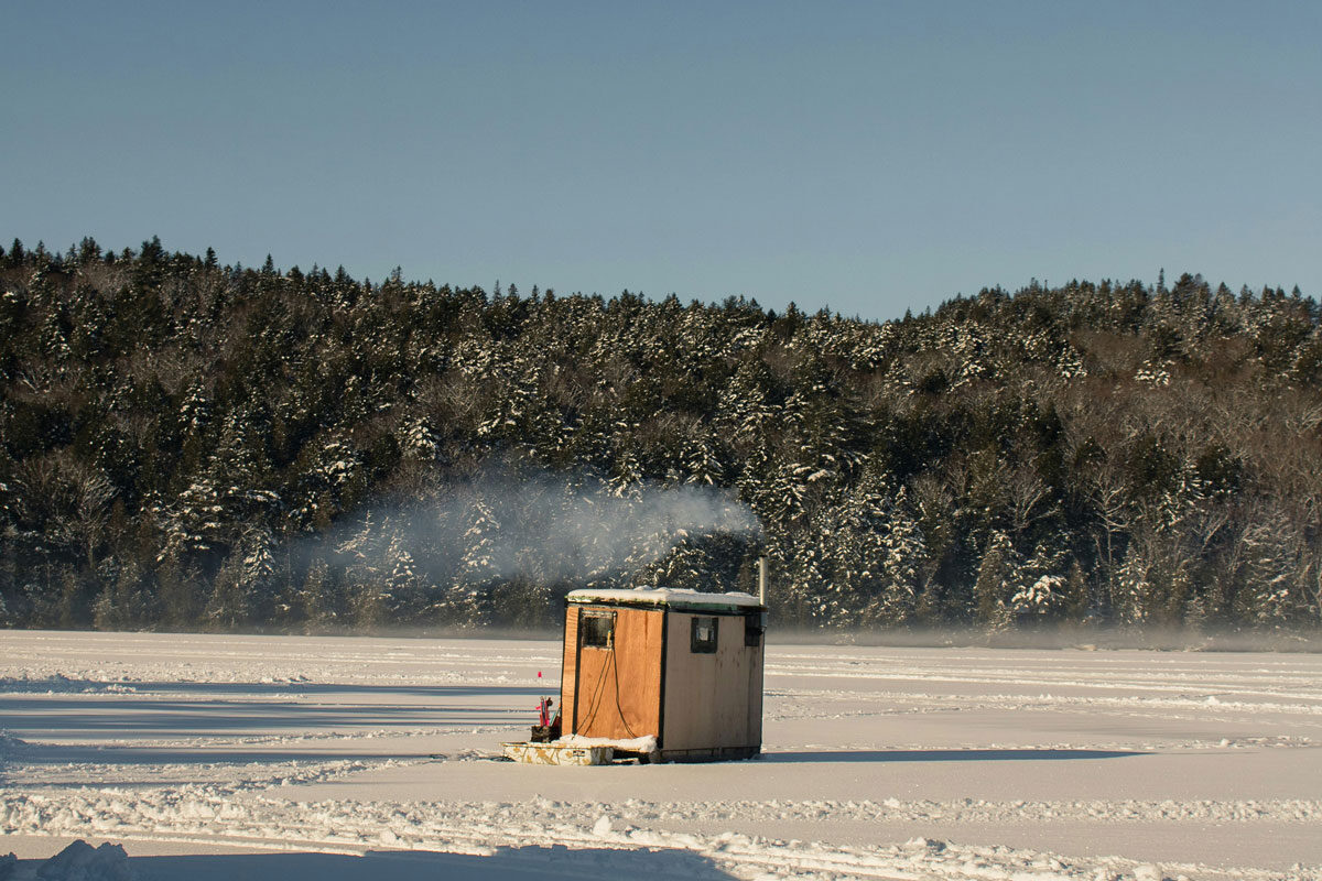 A small ice fishing shack on a pond in Acadia National Park, Maine